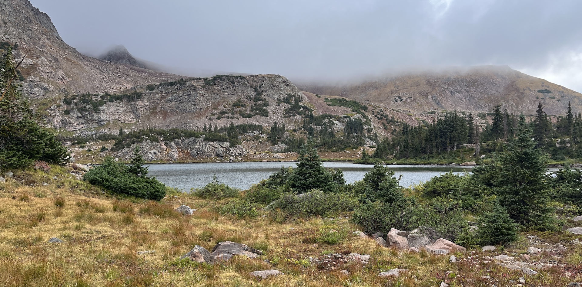 One of the lakes with clouds hiding the mountain tops in the background